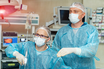 Operation medical emergency hospital treatment. Group of surgeons working in emergency hospital room.