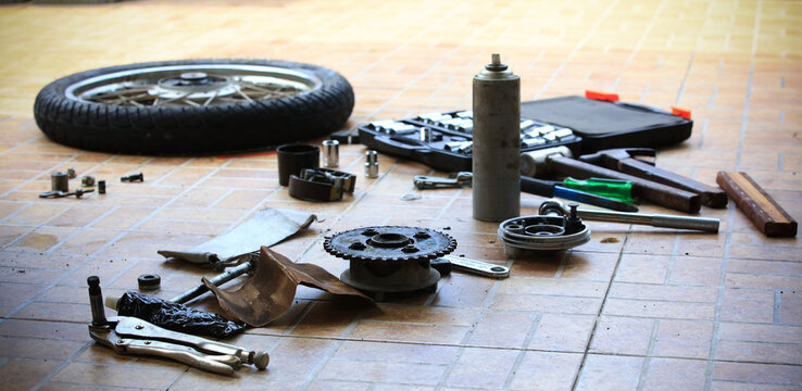 Disassembly Of Motocycle Parts On Floor At Garage