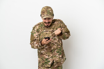 Soldier man isolated on white background surprised and sending a message