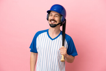 Young caucasian man playing baseball isolated on pink background thinking an idea while looking up