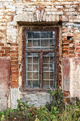 Fototapeta na wymiar Window of an old abandoned brick house