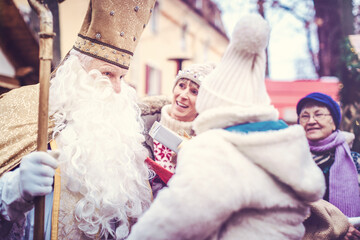 St Nicholas and an extended family with child on the Christmas market
