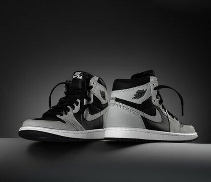 24.10.2021. Sneakers black grey Air Jordan 1 Retro High OG Shadow 2.0, dark background. concept photo for shoes store. copy space