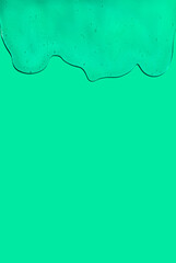 Spilled see through slime over green background. Halloween spooky concept. Creative copy space.
