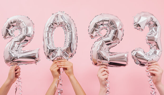 Festive balloons in from the numbers 2023 on a pink background.