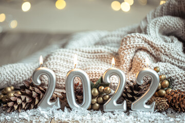 Festive New Year background with candles in the form of the numbers 2022.