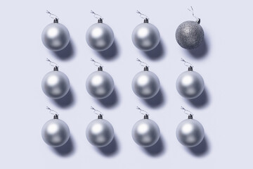 Geometrical composition with silver tree ornaments on bright gray background. Creative Christmas or New year concept. Minimal individuality, leadership or think different idea. Flat lay.