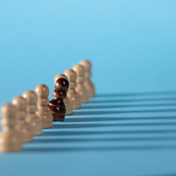 chess pieces in a row, white pawns on a blue background,