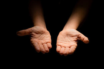 Fototapeta premium Two hands with open palms turned up, offering or giving something, a handful.