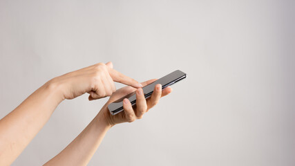 Use mobile apps, scroll. Smartphone, the female hand uses the touchpad.