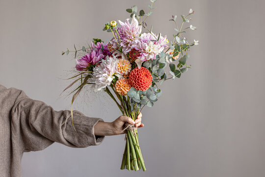 A bouquet of beautiful chrysanthemums in a woman's hand, copy space.