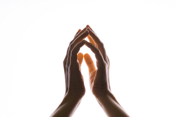 Praying hands on a white background. Light from above. Hands folded in prayer. Hand gestures