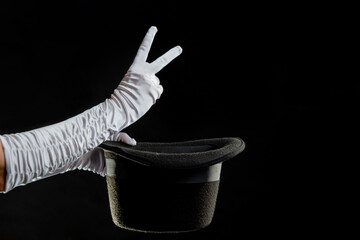 Hand gestures. Showman shows disappearing tricks in a hat, white gloves and black top hat,