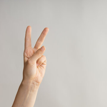 Hand gestures, Two thumbs up, a victory gesture. Women's hand