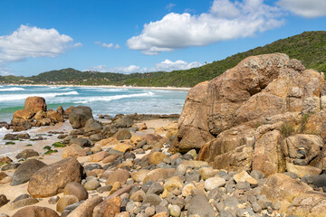Fototapeta na wymiar Rocks with algaes, sand and waves
