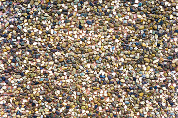 Texture of a brown ceramic stones. Ridge brown background of a facade. Ceramic surface.  Texture from small colored darkly pebble. Mosaic flooring, colored  stones.