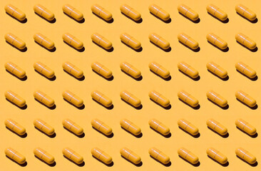 Pills pattern. Set yellow pills isolated on yellow background. Trendy pattern made with Pharmaceutical medicine tablets on yellow background. Medicine concept.