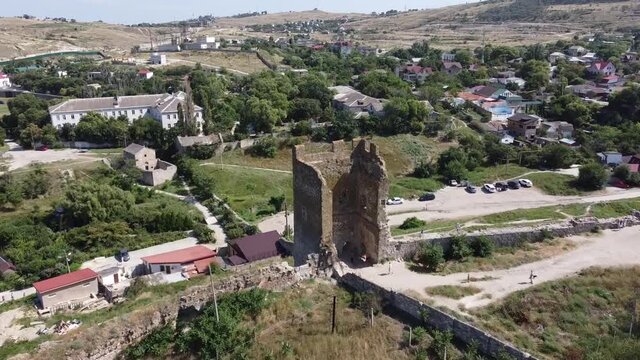 Drone flight over the Tower of ancient ruined Genoese fortress Kaffa. Aerial dolly shot.
