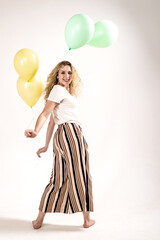 Funny girl with colored balls on a white background. (isolated on white)
