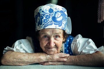Portrait closeup of an elderly woman in ethnic Eastern European. - obrazy, fototapety, plakaty