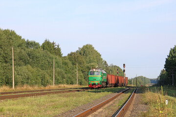 early sunny morning freight train arrives at railway station