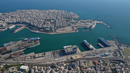 Obraz premium Aerial drone photo of famous and busy port of Piraeus where passenger ferries travel to Aegean destination islands as seen from high altitude , Attica, Greece