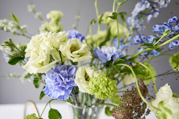 Finished flower arrangement in a vase for home. Flowers bunch, set for interior. Fresh cut flowers for decoration home. European floral shop. Delivery fresh cut flower.