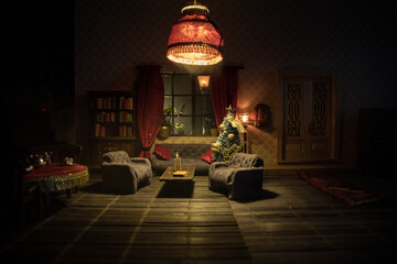 A realistic dollhouse living room with furniture and window at night. Artwork table decoration with handmade realistic dollhouse. Selective focus.