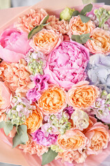 closeup Pink peonies and hydrangea. Beautiful bouquet of mixed flowers in woman hand. Floral shop concept . Handsome fresh bouquet. Flowers delivery.