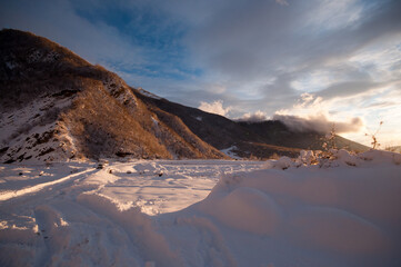 Majestic sunset in the winter mountains landscape. Dramatic sky. Azerbaijan nature.