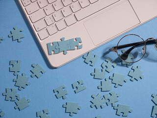 Puzzle elements in a chain of several blocks on a laptop keyboard,