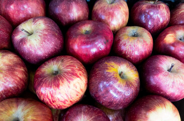 Fruits and vegetables background.  Healthy Living: Elevate Your Well-being with Nutritious Habits!  Close-up of apples in a supermarket.