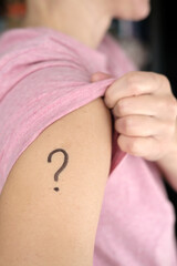 Shoulder with a drawn question mark. Concept of uncertainty, whether or not to vaccinate against...