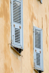Window shutters partially open for cooling, in the town of Ajaccio, Corsica.