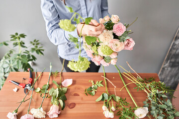 Education in the school of floristry. Master class on making bouquets. Summer bouquet. Learning flower arranging, making beautiful bouquets with your own hands. Flowers delivery