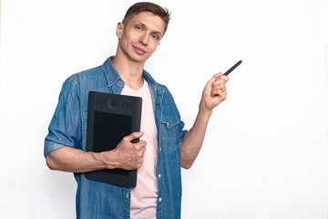 A male designer in casual style holding graphic tablet