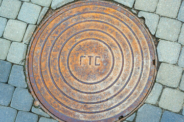 Metallic manhole cover of the city sewerage close-up.