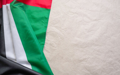 December 2 is the Independence Day of the United Arab Emirates. UAE flag on a background of craft, crumpled parchment paper with place for text