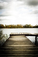 A pier over the lake in autumn, a nostalgic atmosphere reminiscent of loneliness