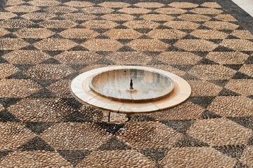 Arab fountain, in a courtyard of orange trees, where several centuries ago, it worked, in an old mosque in Andalusia (Spain).