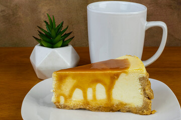 carmel top cheese cake  with a cup of coffee