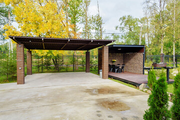 Picnic area with barbecue grill and table and chairs.