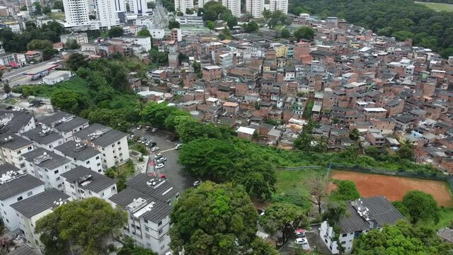 salvador, bahia, brazil - october 24, 2021: aerial view of slum dwellings next to a popular apartment complex in the Cabula neighborhood in the city of salvador.