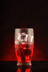 glass with alcohol and ice cubes