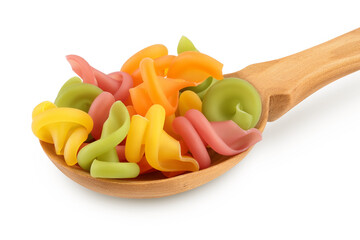Raw colored pasta in wooden spoon isolated on white background with clipping path and full depth of field