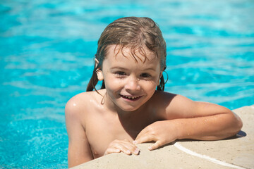 Portrait of child boy swim in swimming pool.