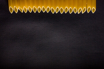 Yellow long spaghetti on a rustic background. Yellow italian pasta. Long spaghetti. Raw spaghetti...