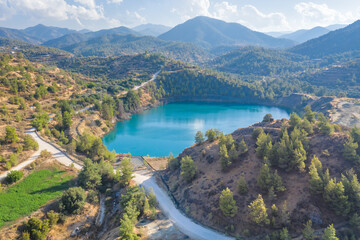 Mine lake from abandoned surface mining in Xyliatos area, Cyprus. Reforestation of old spoil heaps from mining