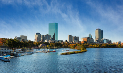 Fototapeta na wymiar Boston Skyline at Autumn showing Charles River Esplanade at early morning with fall foliage. The Charles River Esplanade of Boston, MA, is a state-owned park in the Back Bay area of the city.