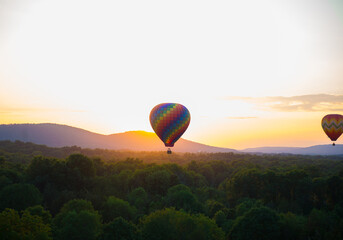Mesmerizing view of colorful hot air balloons into the sky during sunset